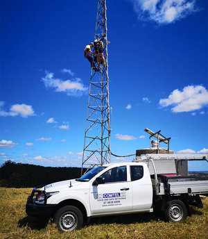 Comtel team members working on a communication tower